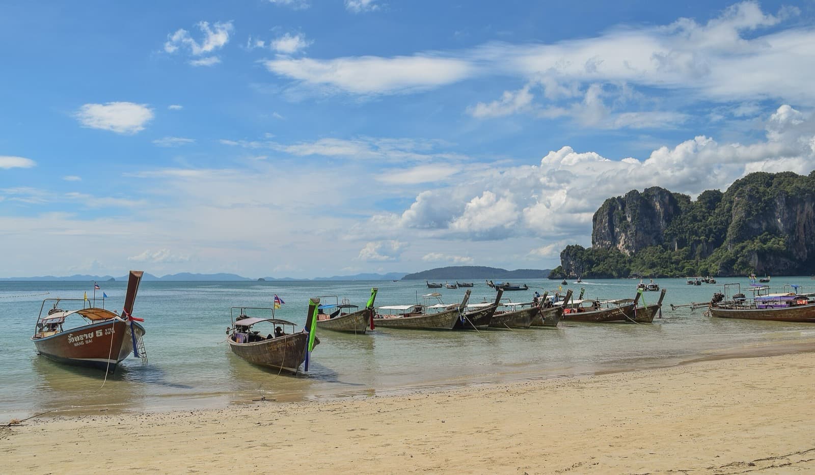 Karst cliffs rising above the sand at West Railay, Krabi