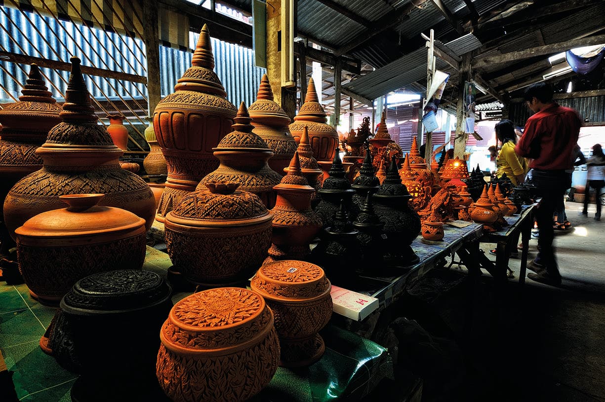 Hand-carved terracotta pottery for sale at a Thai craft market